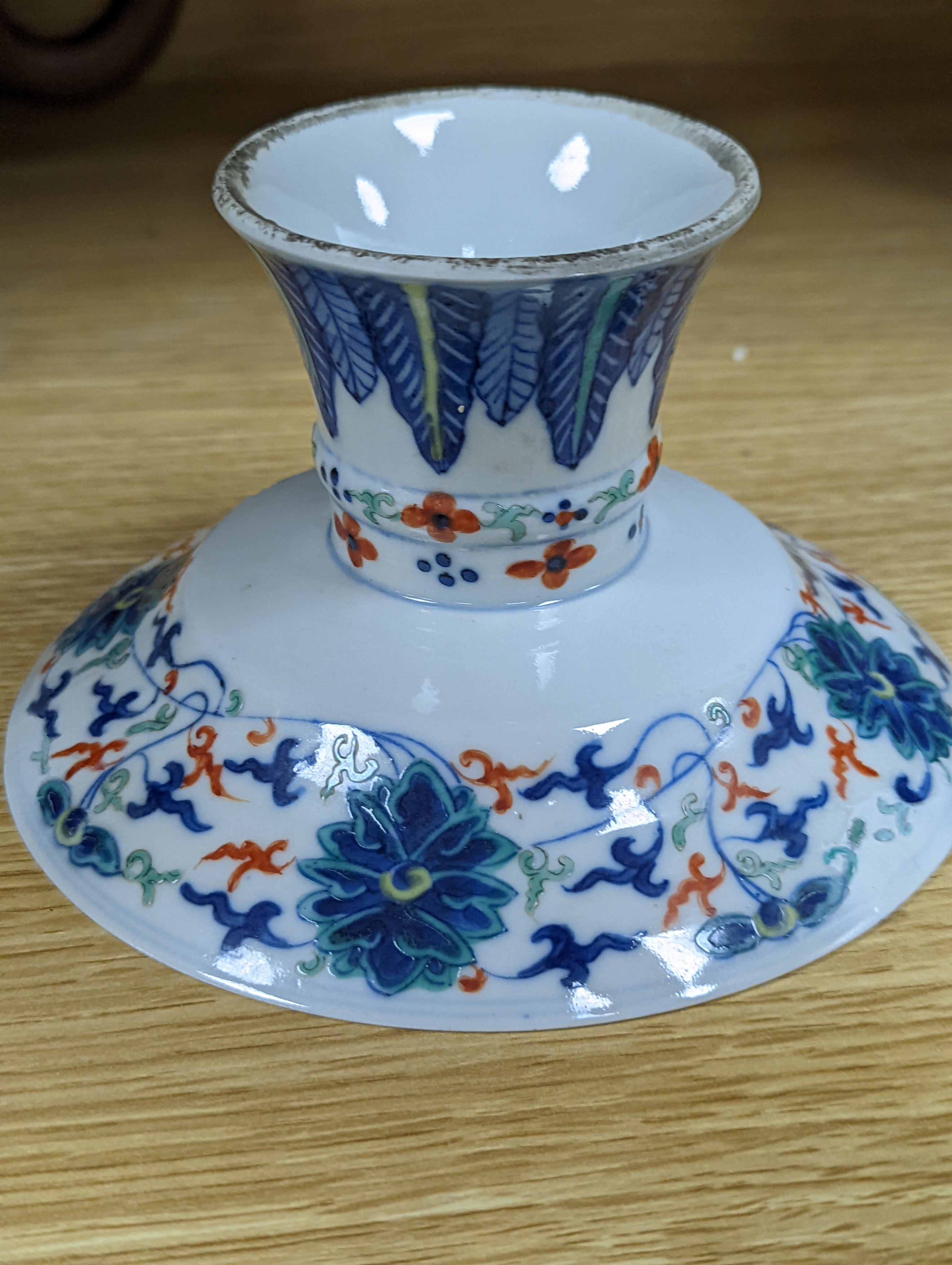 A Chinese blue and white water pipe vessel, a doucai stem dish and a Japanese Imari bowl, 19th century, (3)